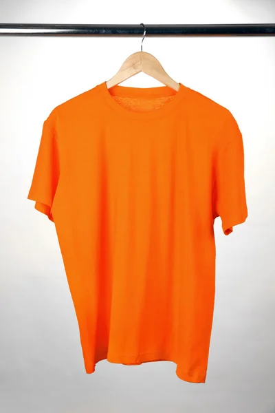 Orange t-shirt on hanger on white background — Stock Photo, Image