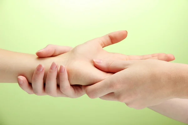 Massagem de mão, no fundo verde — Fotografia de Stock