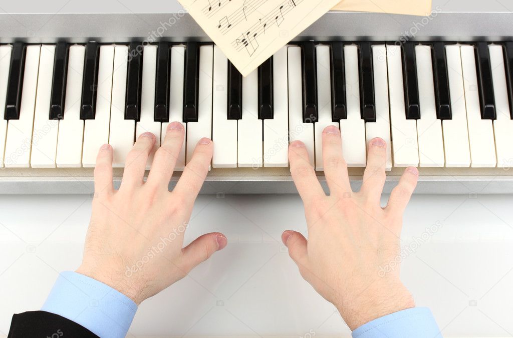Hands of man playing piano