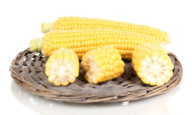 Fresh corn on wicker mat isolated on white clipart