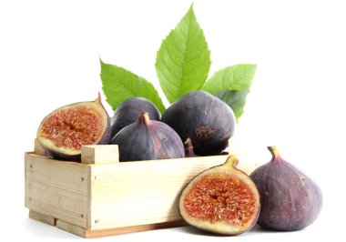 Ripe sweet figs with leaves in wooden crate isolated on white clipart