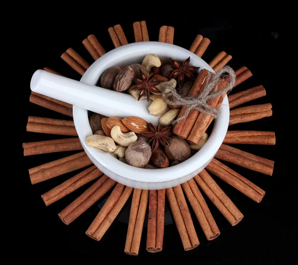 Состав раствора с орехами и корицей на изолированном на сером — стоковое фото