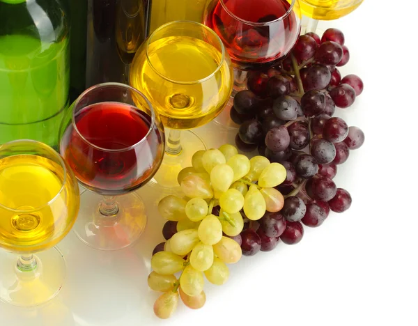 Бутылки и бокалы вина и спелых винограда изолированы на белом — стоковое фото