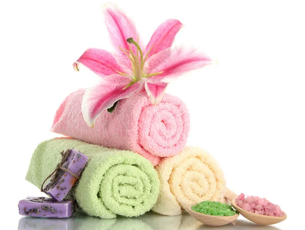 Towels with beautiful pink lily, aroma oil and sea salt isolated on white — Stock Photo, Image