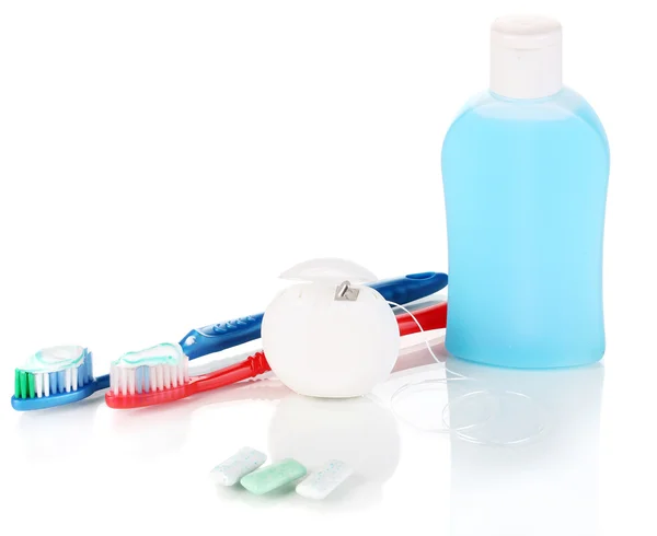 Toothbrush, chewing gum and dental floss isolated on white — Stock Photo, Image