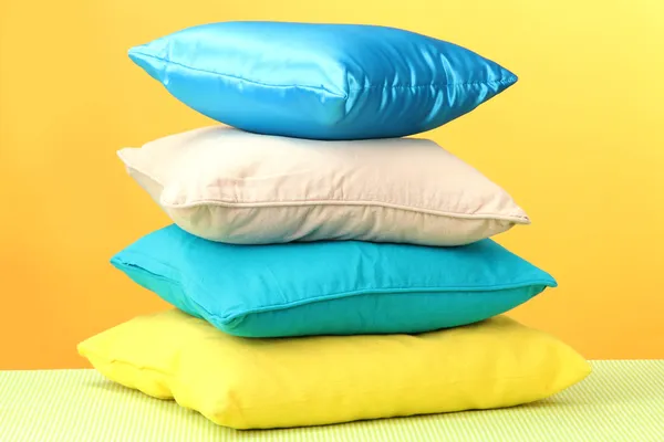 Sarı arka plan üzerinde renkli yastıklar — Stok fotoğraf