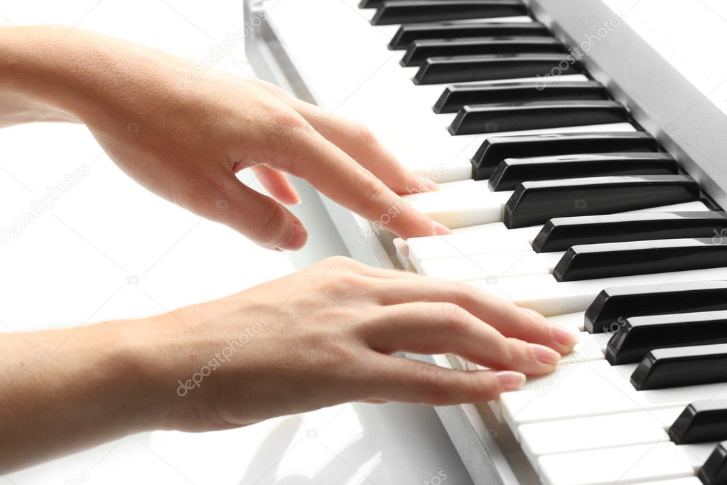 Hands of woman playing synthesizer