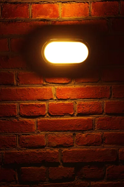 stock image Old red brick wall with street light