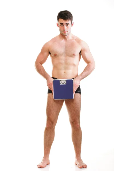 Healthy young man with a weight scale Isolated — Stock Photo, Image