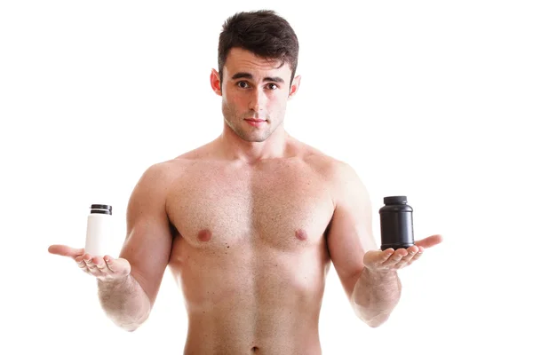 Sexy masculino construtor de corpo segurando um caixas com suplementos no seu b — Fotografia de Stock