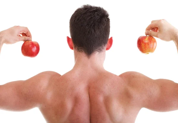 Urheilullinen seksikäs mies kehonrakentaja tilalla punainen omena — kuvapankkivalokuva
