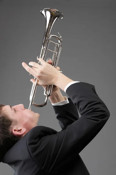 Porträt eines jungen Mannes, der seine Trompete spielt — Stockfoto