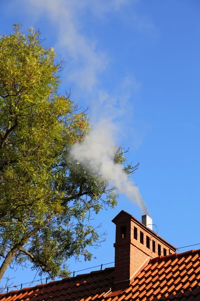 stock image Smoke from a chimney sky blue