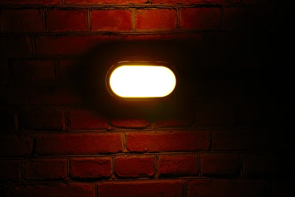 stock image Old red brick wall with street light