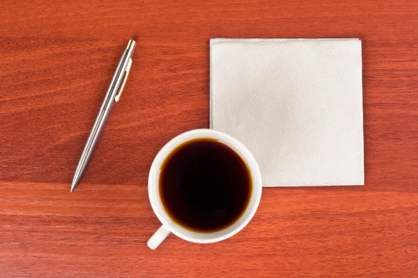 Cup of coffee and napkin — Stock Photo, Image