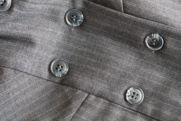 Knopf an einem grauen Anzug — Stockfoto