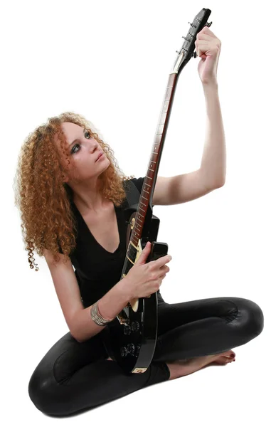 Curly-haired girl and a guitar isolated — Stock Photo, Image