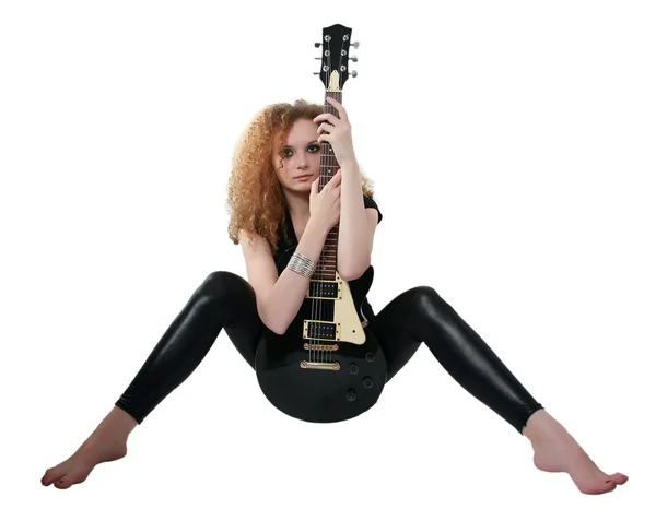 Curly-haired girl sitting with a guitar — Stock Photo, Image
