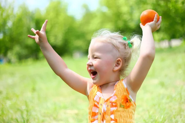Portrait of happy girl plays with oranges — Stock Photo, Image