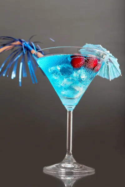 Blue cocktail with ice and umbrella — Stock Photo, Image