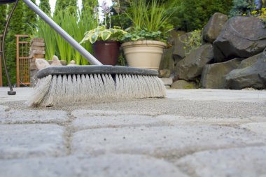 Broom Sweeping Sand into Pavers Low View clipart