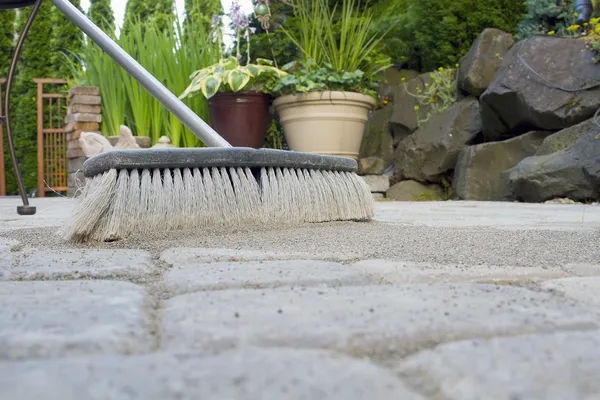 Broom Sweeping Sand into Pavers Low View — Stock Photo, Image