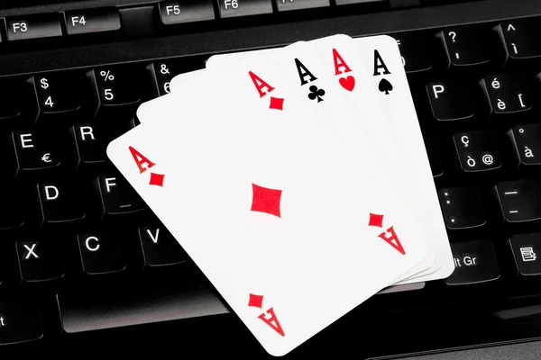 stock image Playing cards on computer keyboard - internet games concept