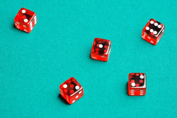 Group of red dices on the green cloth — Stock Photo, Image