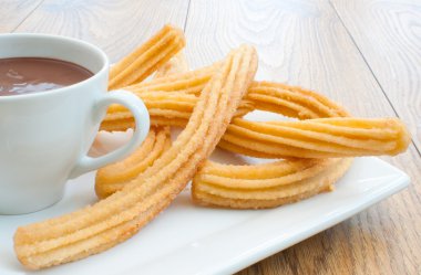 Churros with chocolate clipart