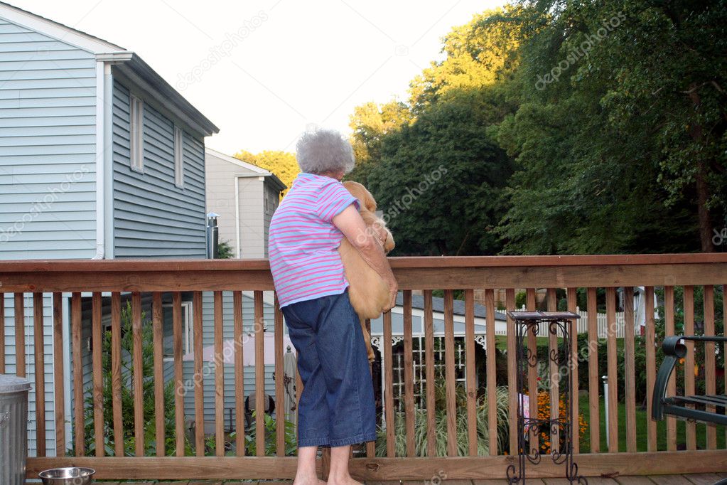 Senior Woman Holding Puppy Horizontal
