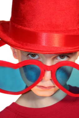Boy Peeking Condescendingly Over Heart-Shaped Glasses clipart