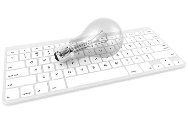 Lâmpada e teclado do computador — Fotografia de Stock