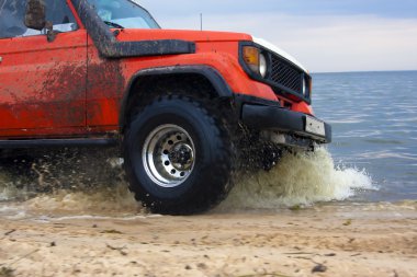 4x4 CUV Crossing the water clipart