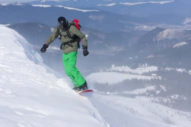 Backcountry freerider on the brink of a precipice. clipart