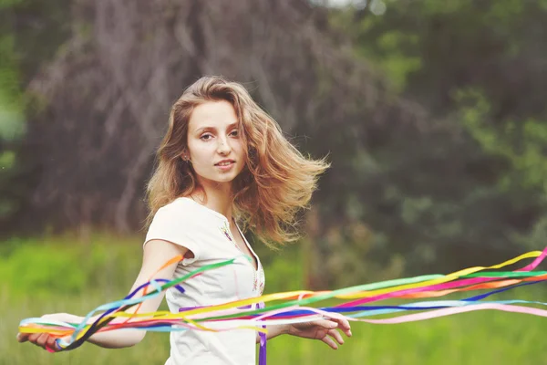 Beautiful girl with ribbons — Stock Photo, Image