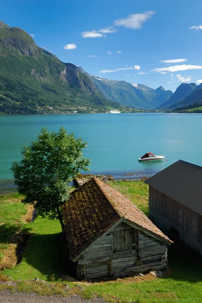 Wood sheds on the shore of fjord. — Stock Photo, Image
