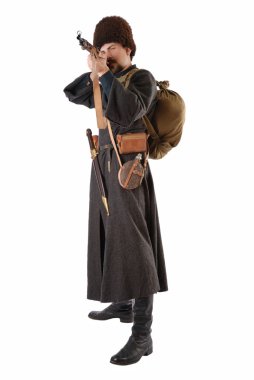 Man in vintage costume of Russian Cossack points a rifle. clipart