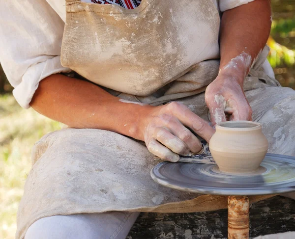 Potter working by the throwing wheel — Stock Photo, Image