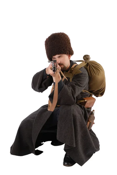 Russian Cossack points a rifle at camera in squatting position. — Stock Photo, Image