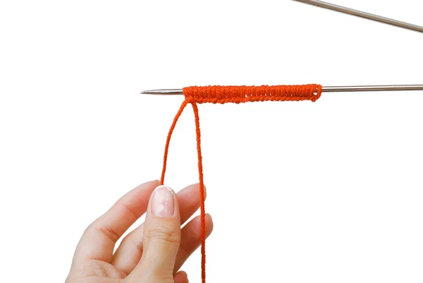 Knitting needle with stitches and hands at the bottom — Stock Photo, Image