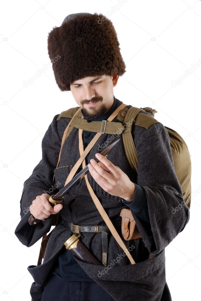 Russian Cossack inspecting a poniard. The living history.