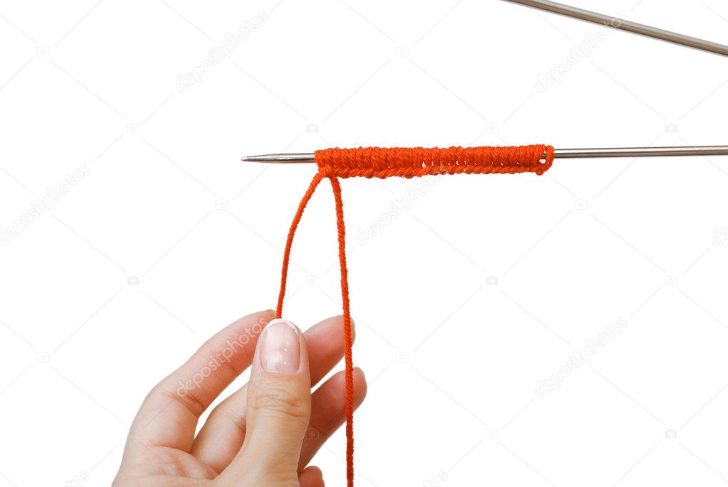 Knitting needle with stitches and hands at the bottom