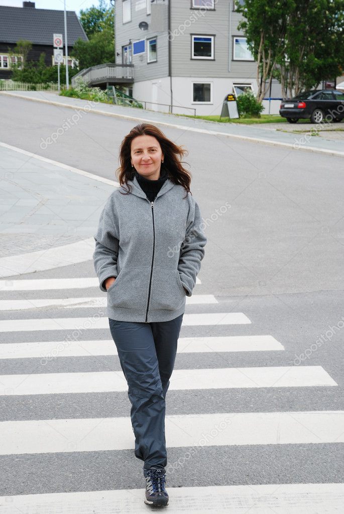 Happy woman on the pedestrian crossing