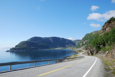 Summer road along the coast of Mageroya. clipart