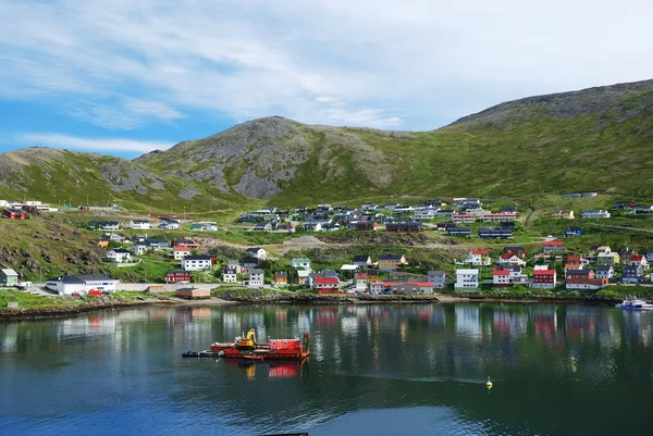 Green hill with fishing town on the side of fjord, Mageroya. — Stockfoto