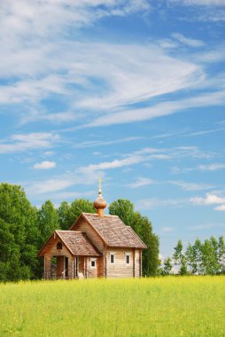 Finnish landscape with small wooden church. clipart