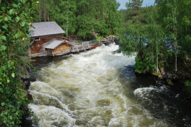 Rapids in taiga forest, Juuma, Finland. clipart