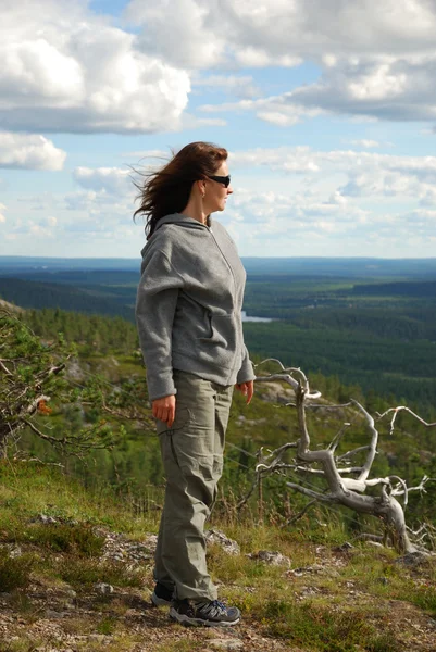 Woman on the green top of summer Finland. — Stock Photo, Image