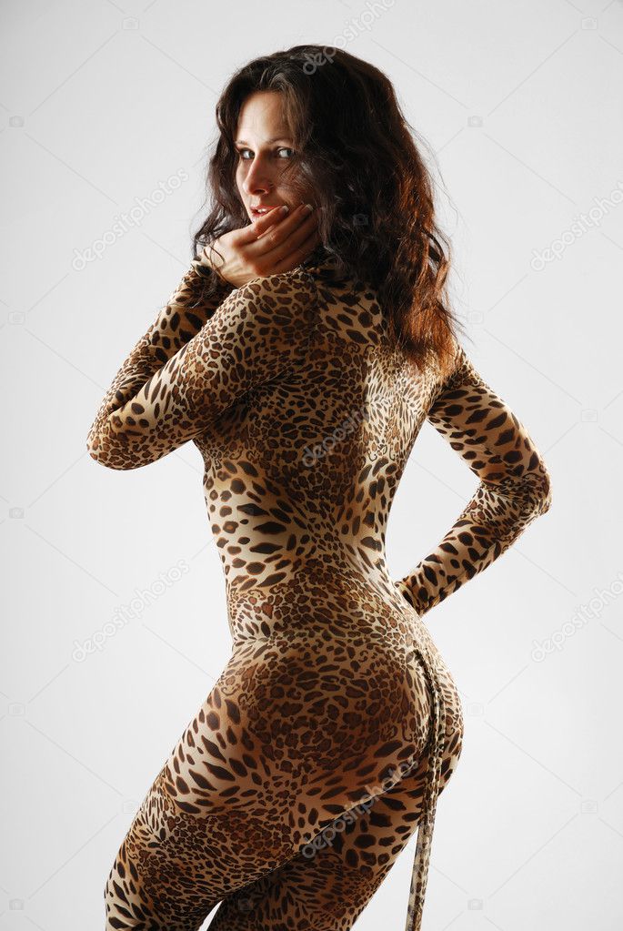 Woman sneaking in dappled catsuit