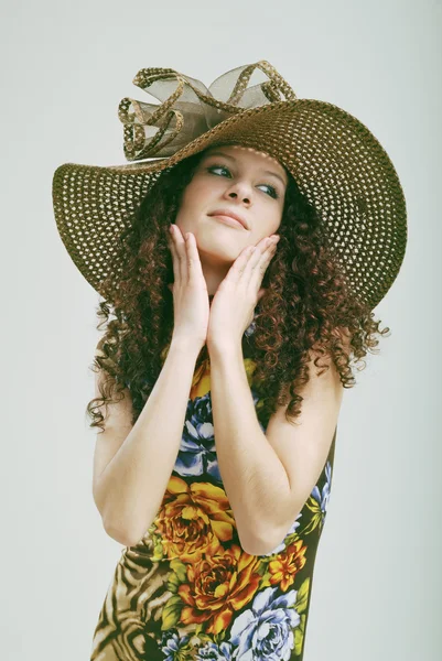 Frizzy girl in a hat. — Stock Photo, Image